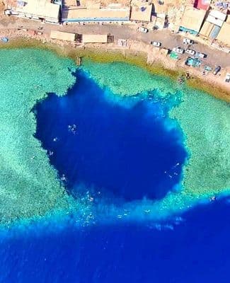 Aerial view of the Blue Hole dive site showing the circular formation