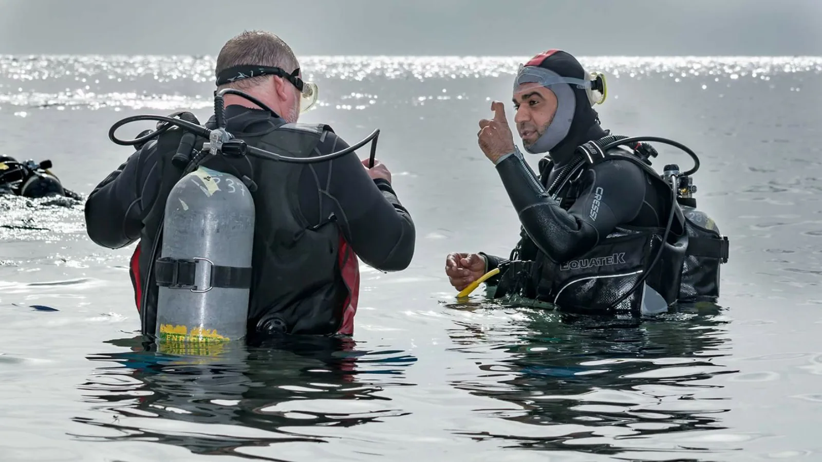 Osama teaching a diving student in the crystal-clear shallow water of Dahab, Egypt